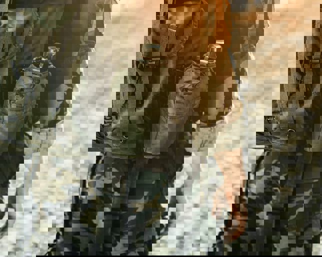 Soldier in military kit performing tasks