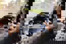 Senior adult hands on wheel